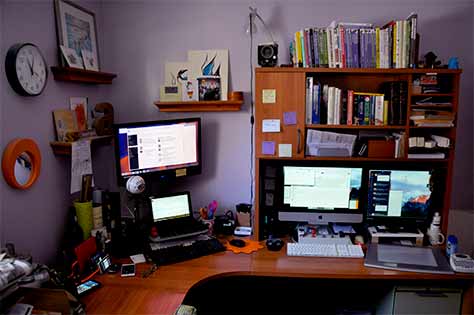 My Mac on the right, my PC in the center, and my many phones and tablets on the left